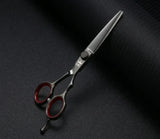 Professional hair cutting scissors with red finger rings on a dark textured background